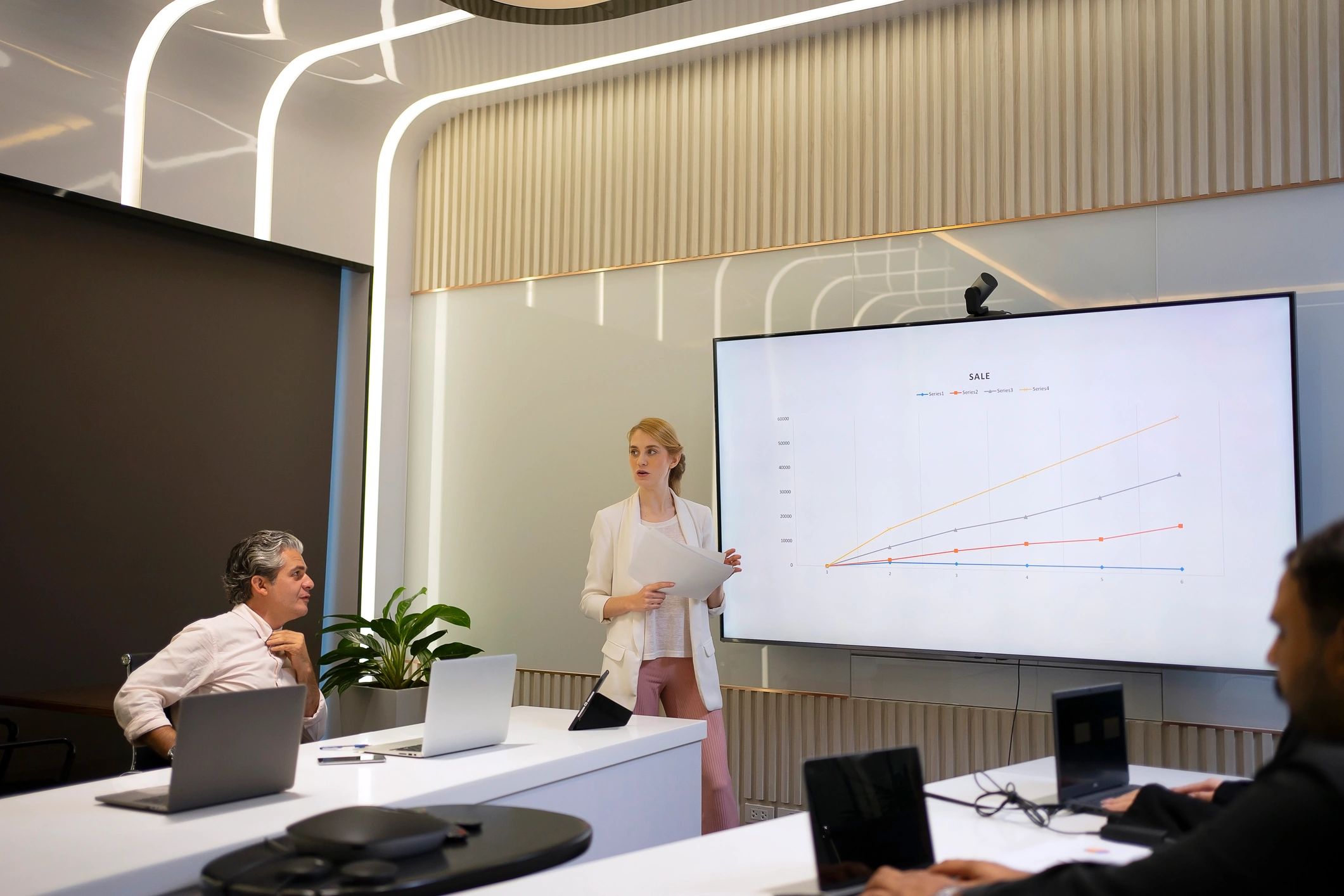 Business team reviewing training materials and whiteboard charts