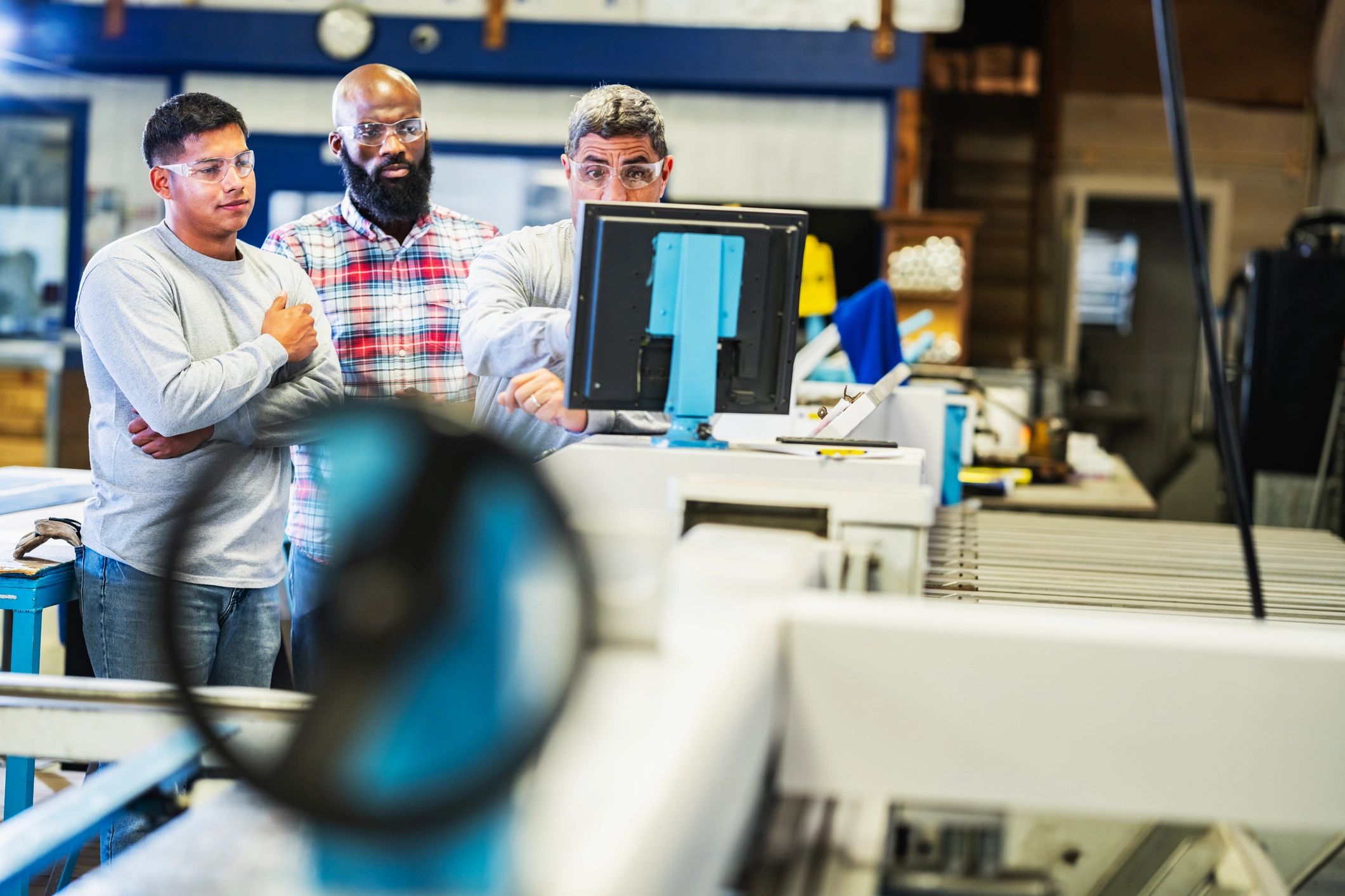 Coach guiding a team on the factory floor